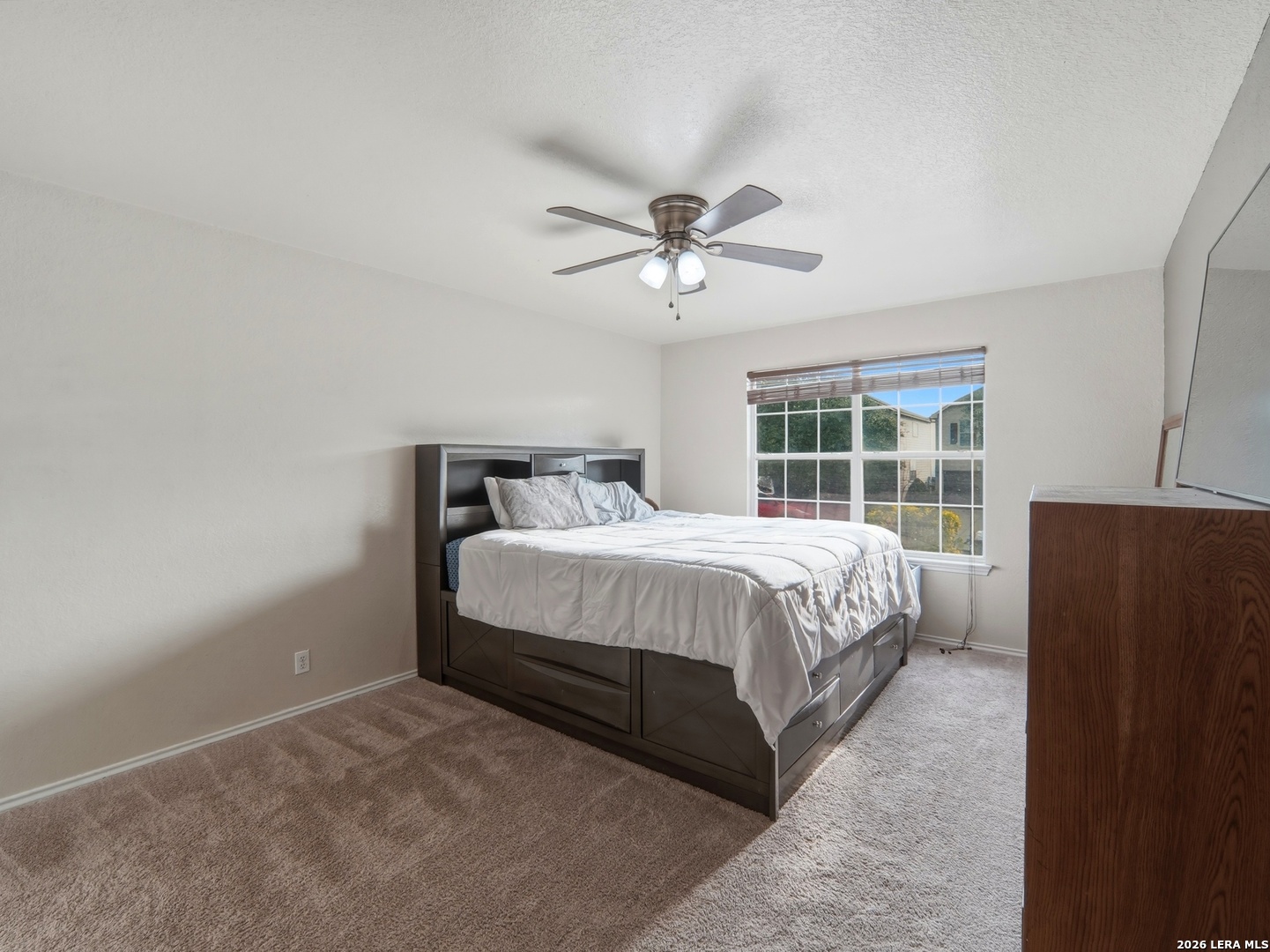 6131 Kensinger Pass Converse, TX 78109 - Photo 12 of 17 a bed sitting in a spacious bedroom next to a window