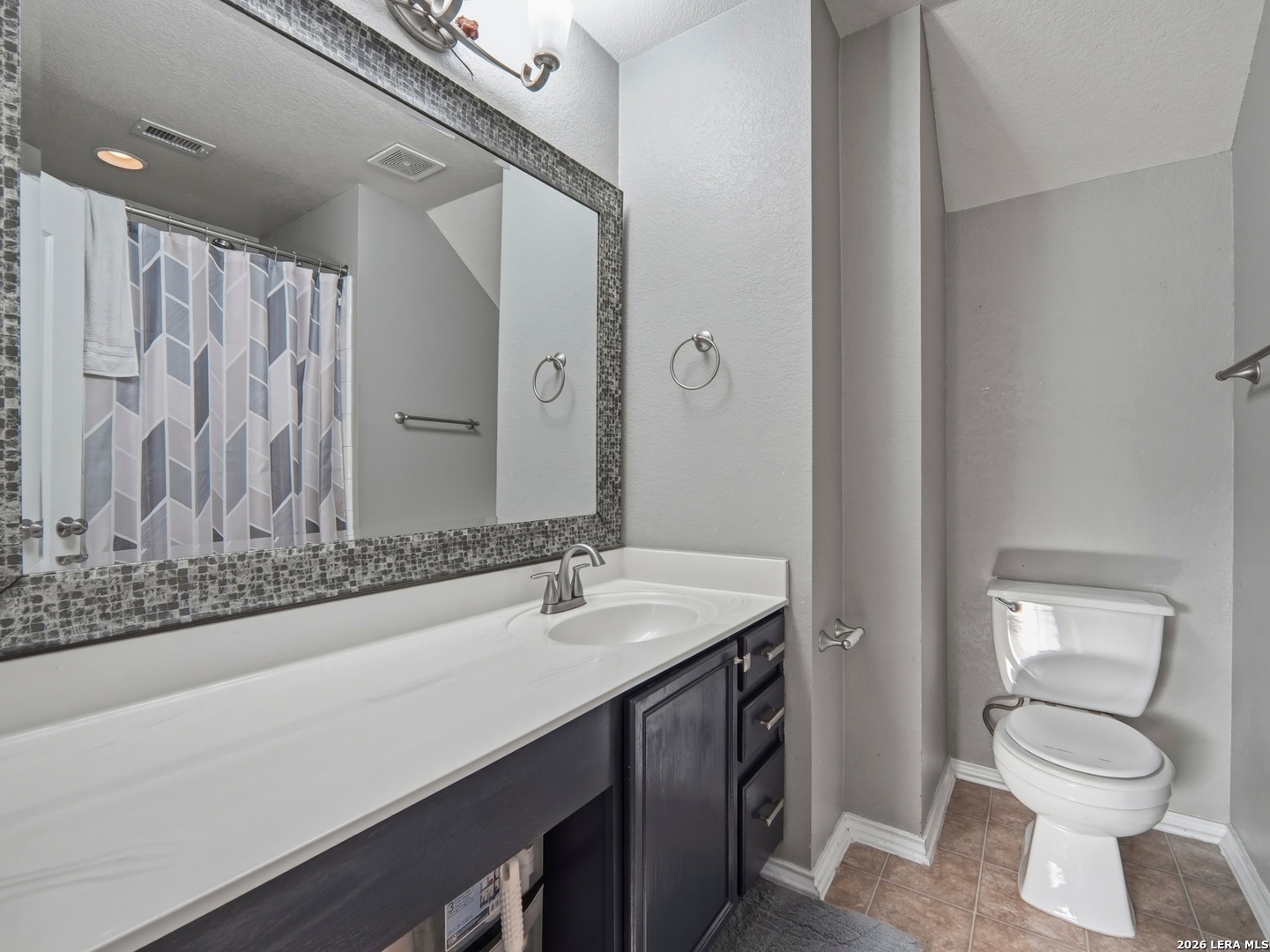 6131 Kensinger Pass Converse, TX 78109 - Photo 13 of 17 a bathroom with a granite countertop sink toilet and shower