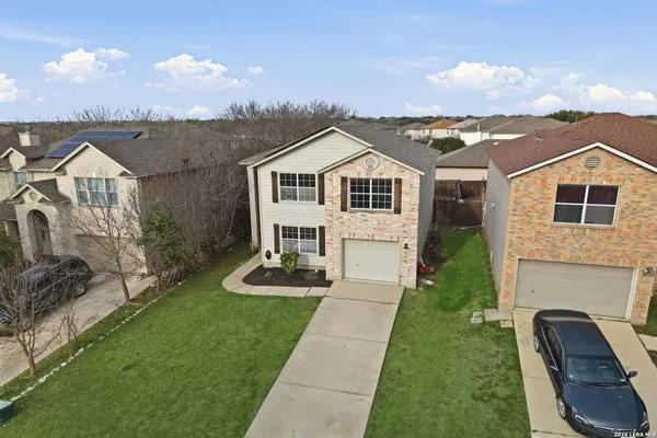 a front view of a house with yard and green space
