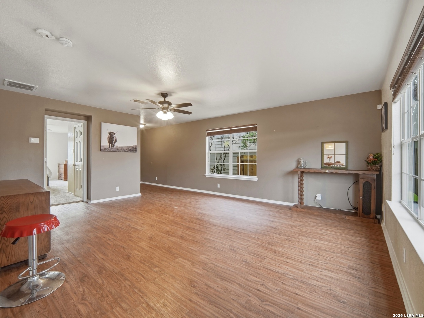 6131 Kensinger Pass Converse, TX 78109 - Photo 5 of 17 a view of an empty room with a window and wooden floor