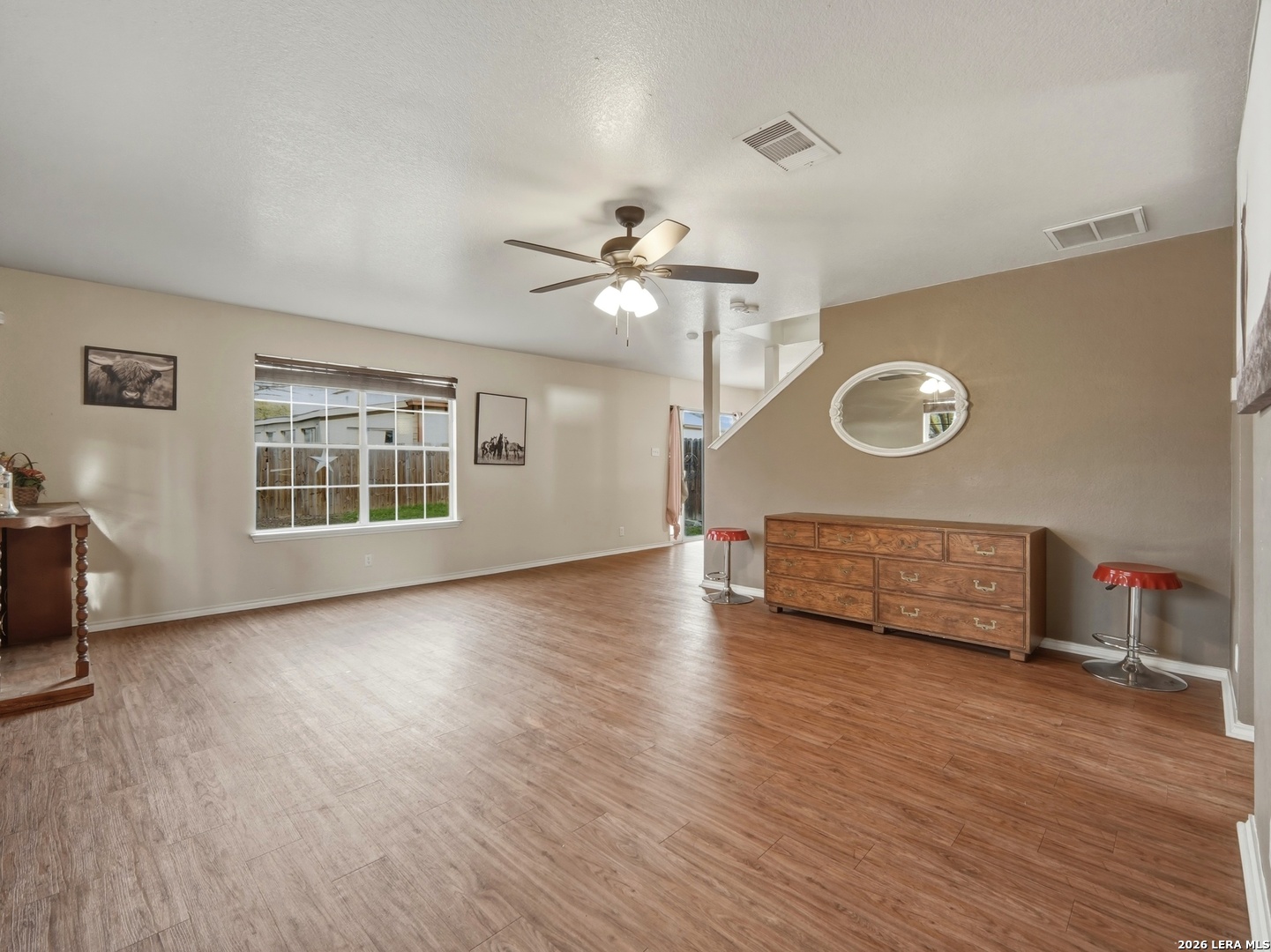 6131 Kensinger Pass Converse, TX 78109 - Photo 6 of 17 a view of an empty room with a window and wooden floor