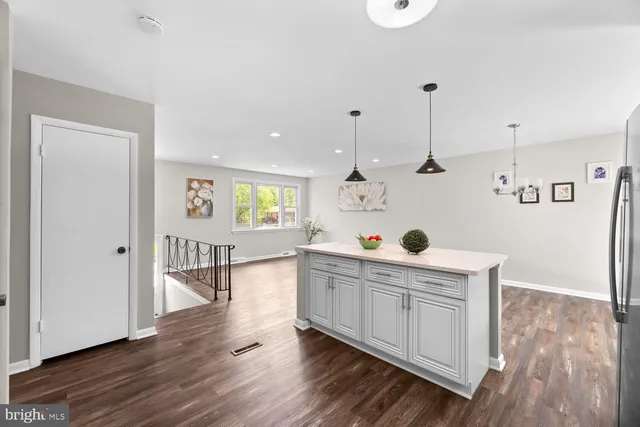 a kitchen with a wooden floor and white appliances