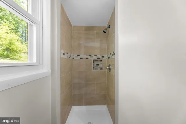 a bathroom with a glass shower door