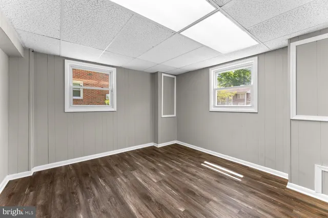 a view of room with window and wooden floor