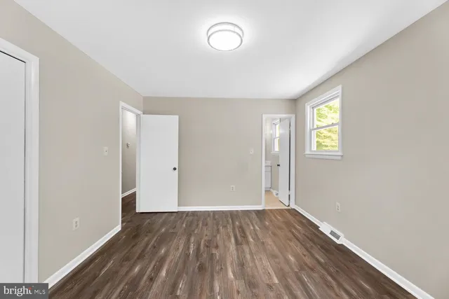 a view of room with wooden floor and window
