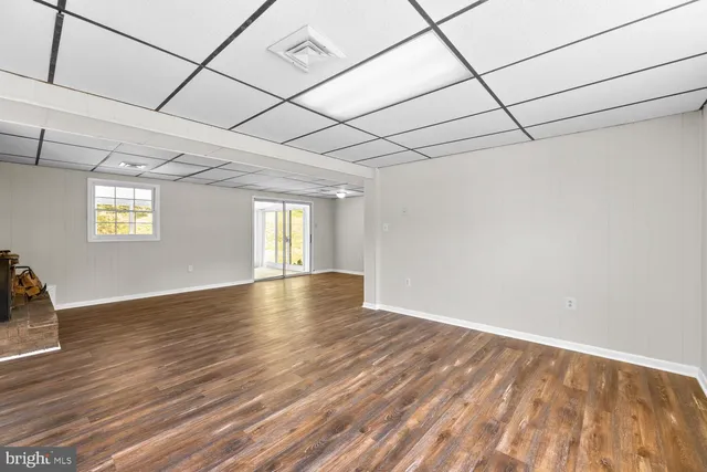 a view of a room with wooden floor and window