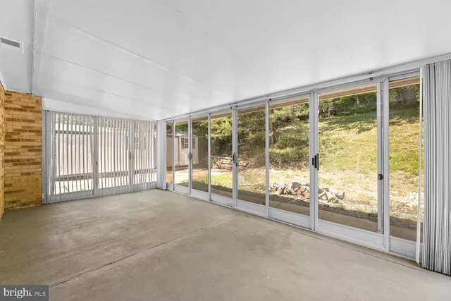 a view of an empty room with windows