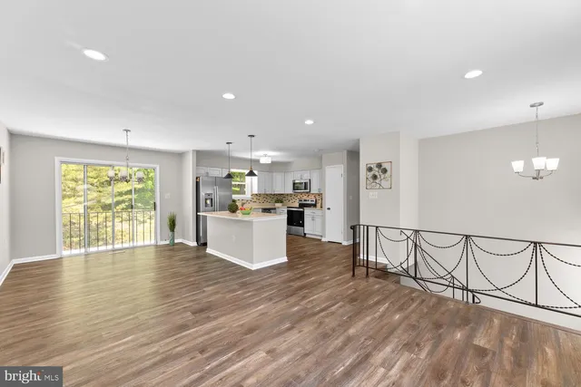 a view of kitchen with furniture and wooden floor