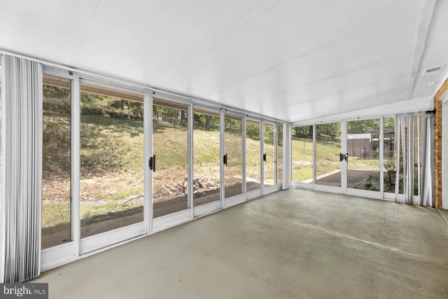 a big room with wooden floor and balcony
