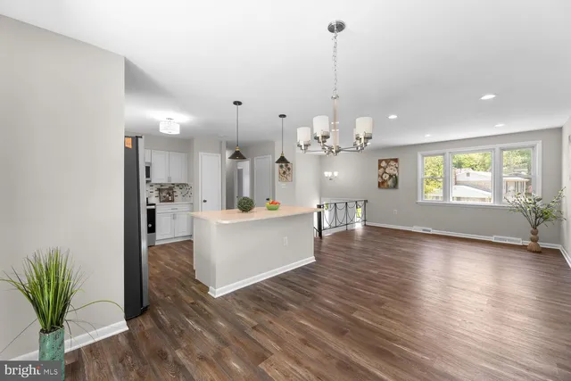 a view of a big room with wooden floor and windows
