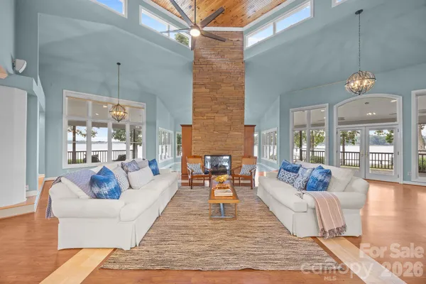 a dining room with furniture a chandelier and wooden floor