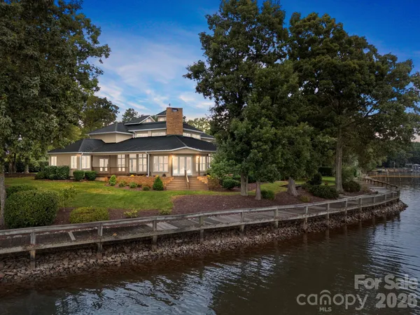 an aerial view of a house with outdoor space and lake view