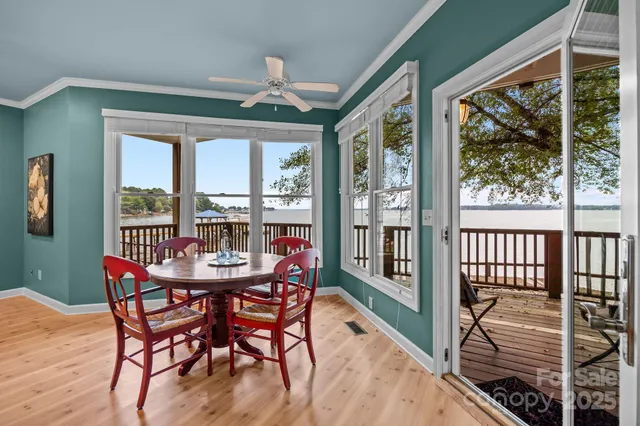 a dining room with furniture large windows and a chandelier