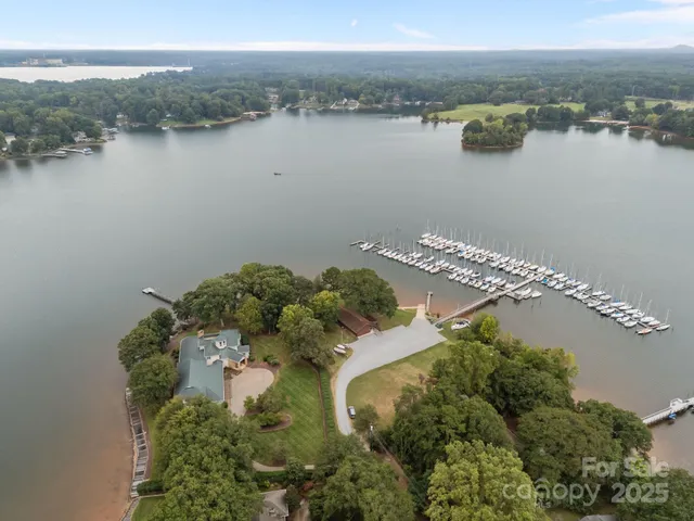 an aerial view of a house with outdoor space and lake view
