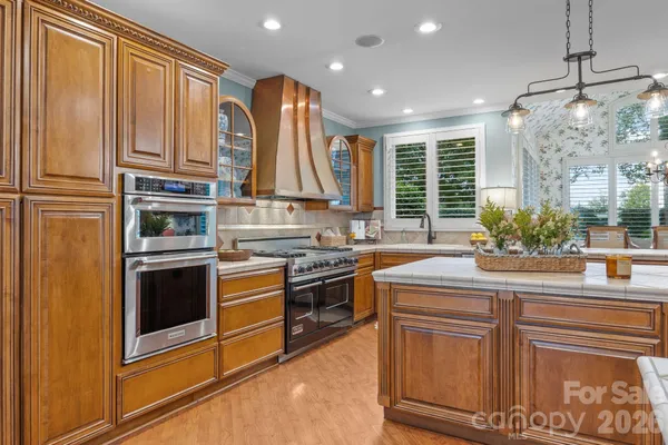 a bathroom with a granite countertop sink a mirror a vanity and a shower