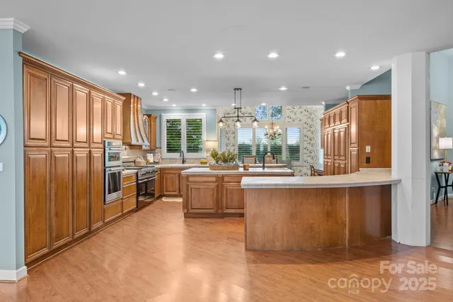 a kitchen with refrigerator cabinets and large window