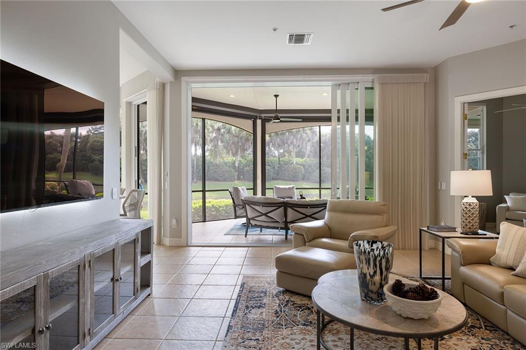 17066 Porta Vecchio Way, Unit 101 Naples, FL 34110 - Photo 1 of 32 a living room with furniture and a large window
