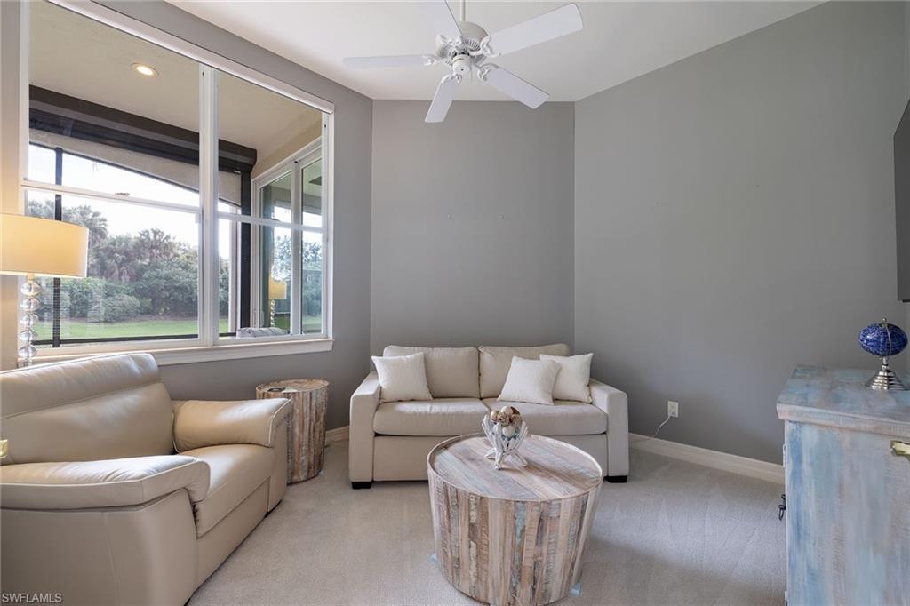 17066 Porta Vecchio Way, Unit 101 Naples, FL 34110 - Photo 15 of 32 a living room with furniture and a large window
