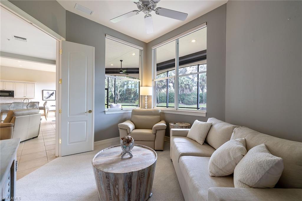 17066 Porta Vecchio Way, Unit 101 Naples, FL 34110 - Photo 16 of 32 a living room with furniture and a large window