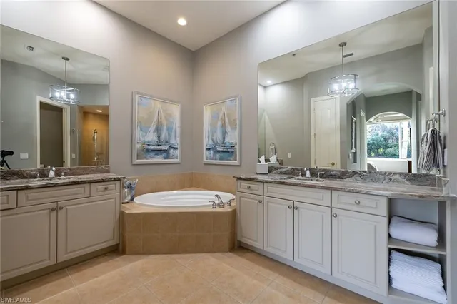 a large bathroom with a double vanity sink and a mirror