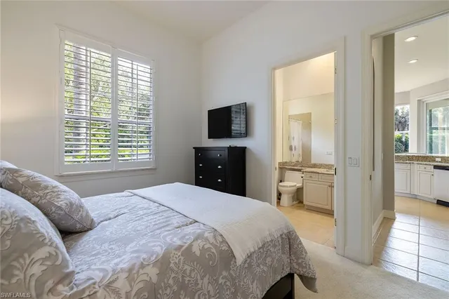 a bedroom with a bed and a television