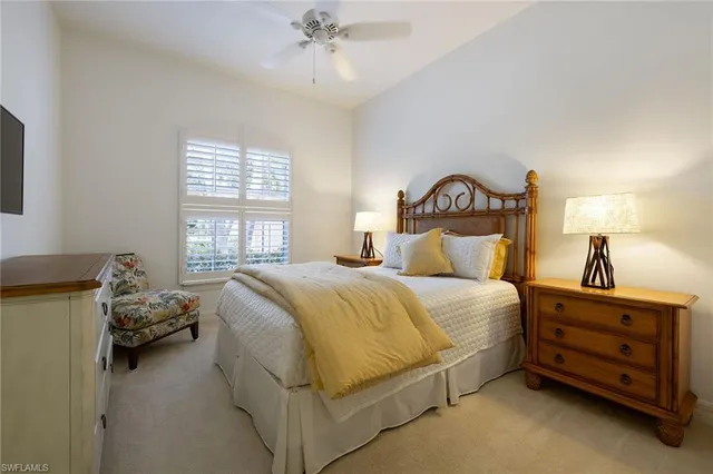 a spacious bedroom with a bed and a chandelier