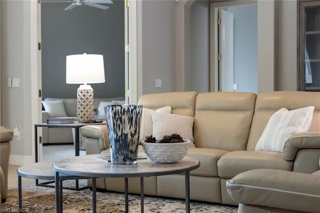 a living room with furniture a mirror and a table