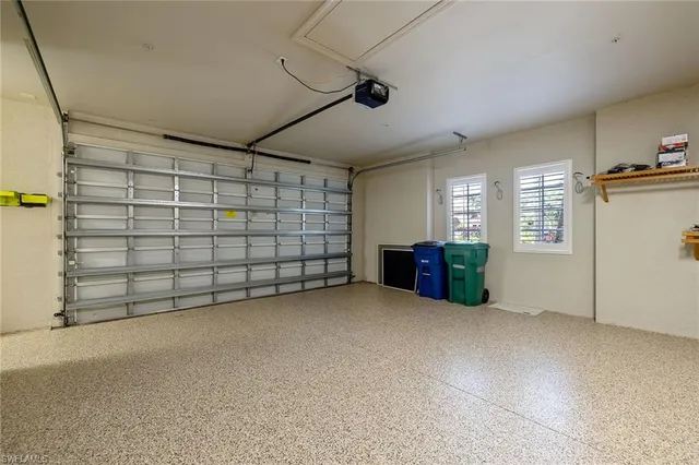 an aerial view of residential house with outdoor space and trees all around