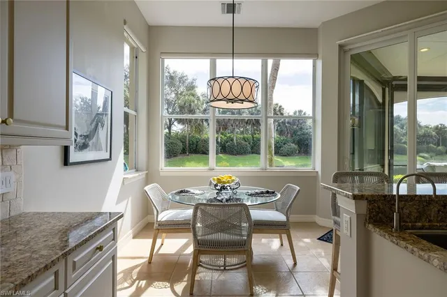 a dining room with furniture a chandelier and wooden floor