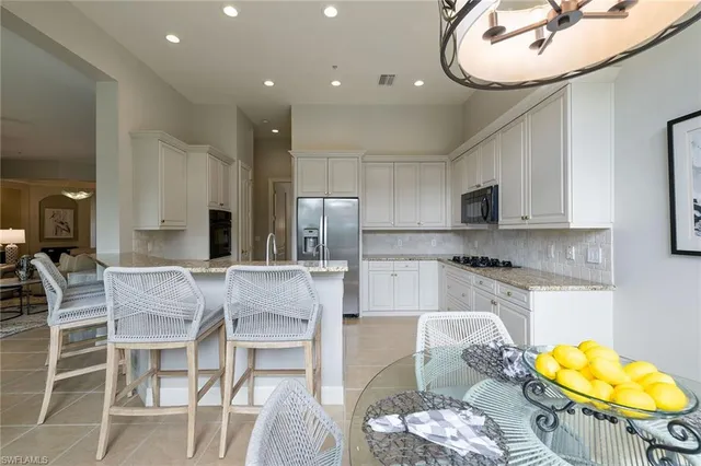 a kitchen with stainless steel appliances kitchen island granite countertop a sink and cabinets