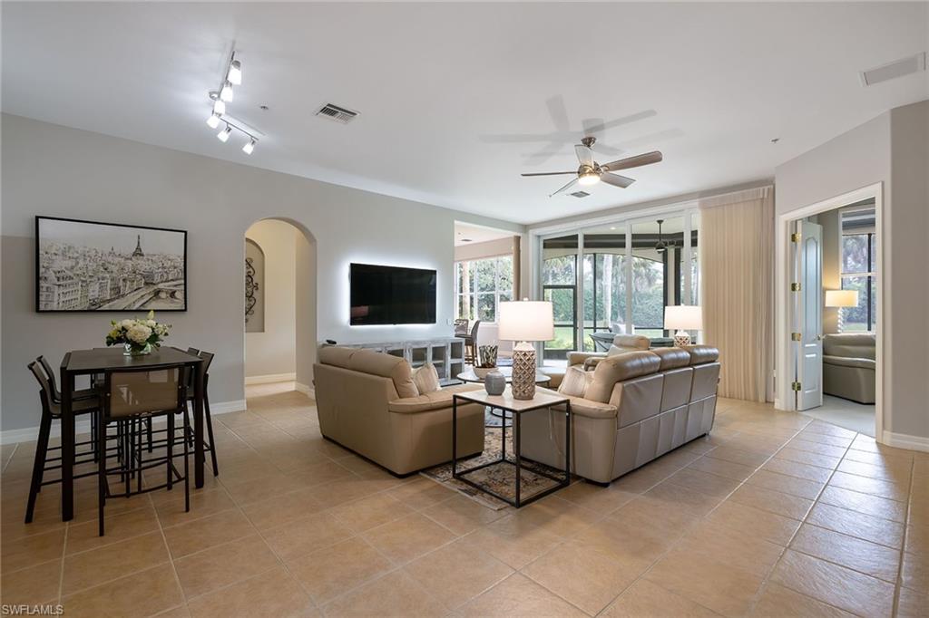 17066 Porta Vecchio Way, Unit 101 Naples, FL 34110 - Photo 10 of 32 a living room with furniture and a flat screen tv