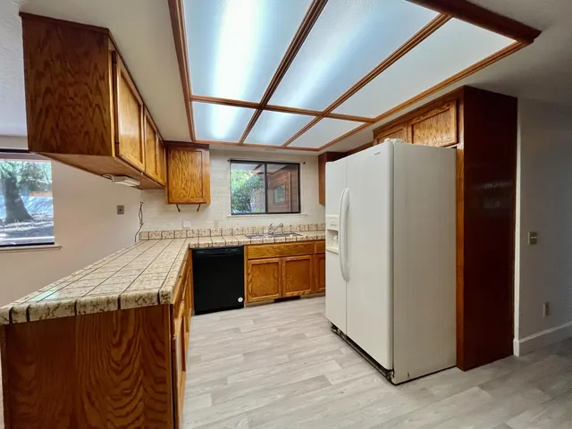 a large kitchen with a large counter top and stainless steel appliances