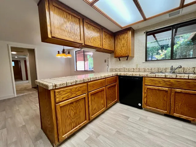a kitchen with stainless steel appliances granite countertop a sink stove and cabinets