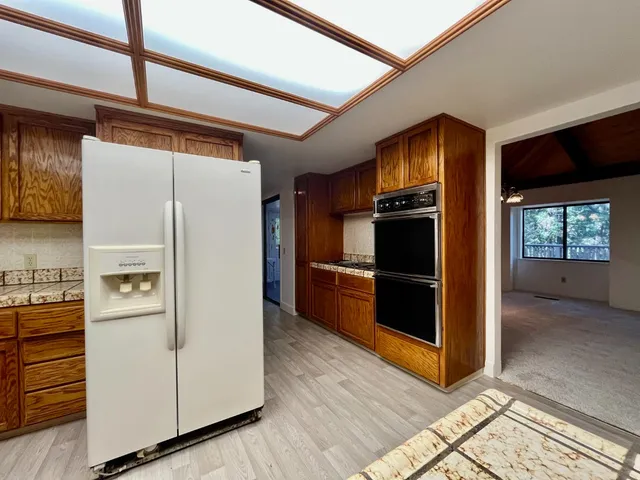 a kitchen with stainless steel appliances a refrigerator and a stove top oven