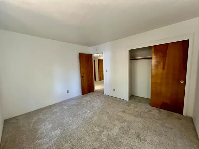 an empty room with closet area