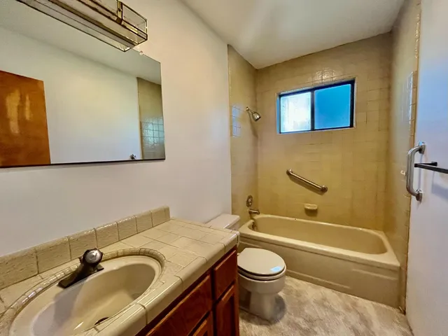 a bathroom with a sink a toilet and bathtub