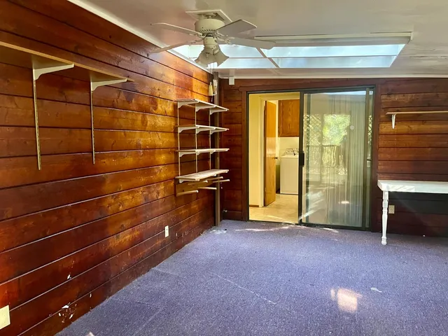 a view of empty room with wooden floor and windows
