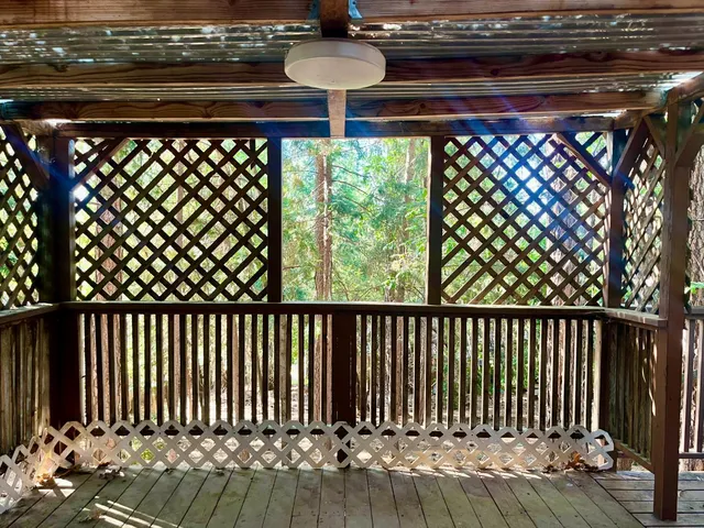 a view of a porch with wooden floor and outdoor space