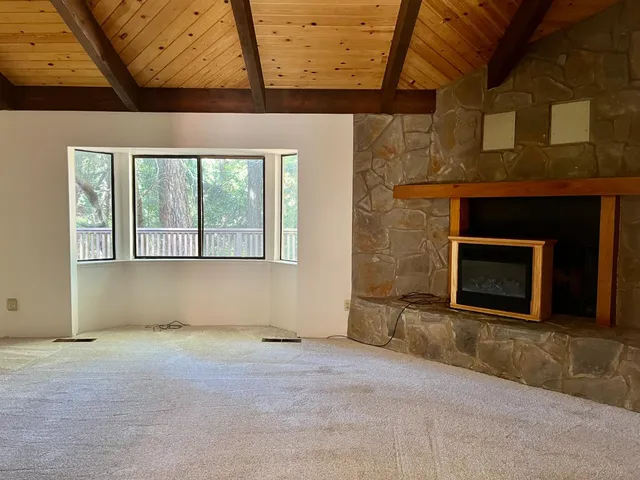 a view of an empty room with a fireplace