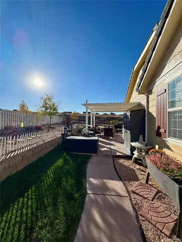 a view of a patio with couches and table and chairs and potted plants