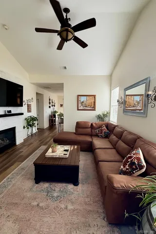 a living room with furniture a fireplace and a flat screen tv