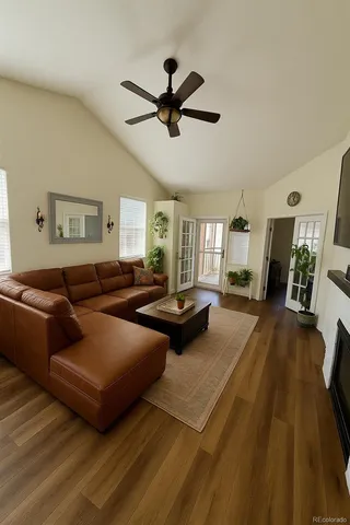 a living room with furniture and a wooden floor