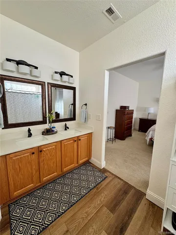 a living room with furniture a flat screen tv and view of kitchen