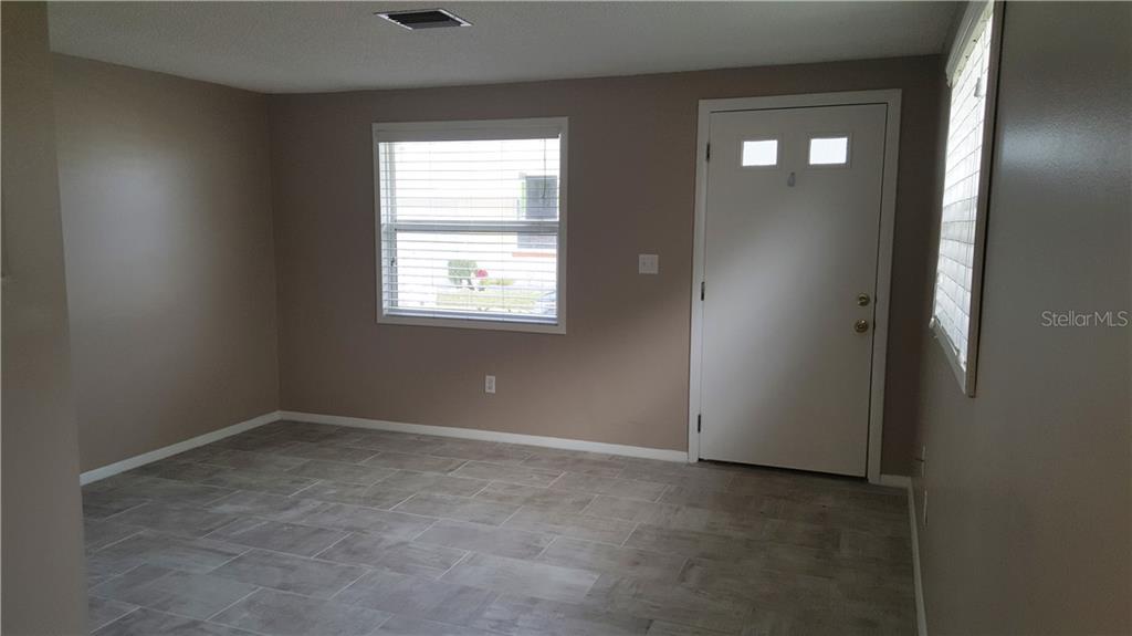 4936 Filner Street New Port Richey, FL 34652 - Photo 1 of 1 an empty room with windows and closet
