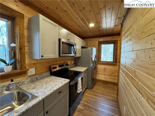 a kitchen with a sink stove and microwave