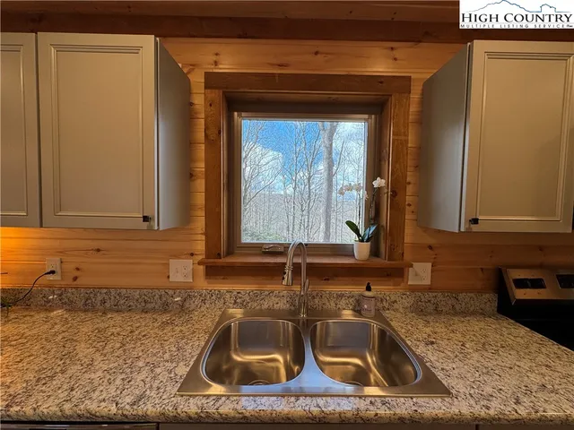 a kitchen with a sink a counter top space and cabinets