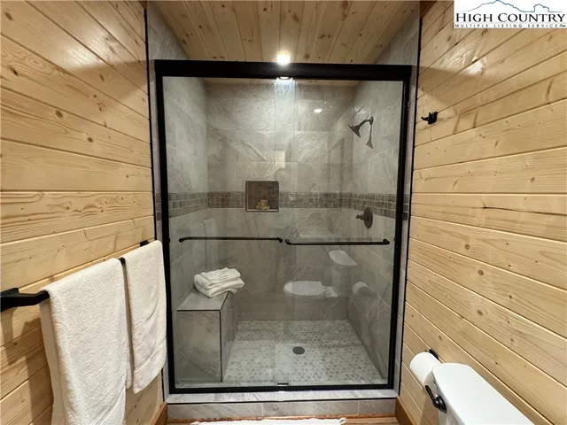 a bathroom with a glass shower door