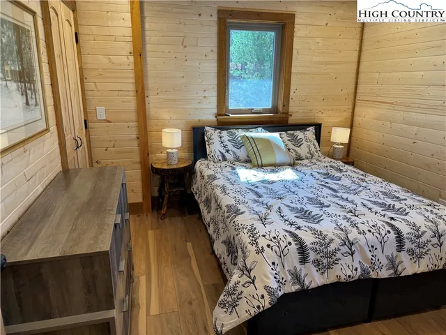 a large bed sitting in a bathroom next to a window