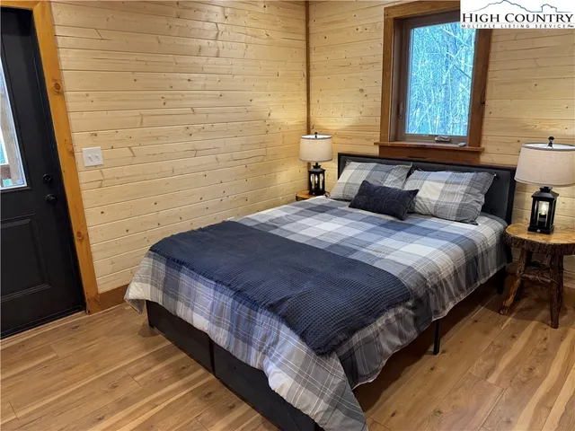 a bedroom with a bed and a window