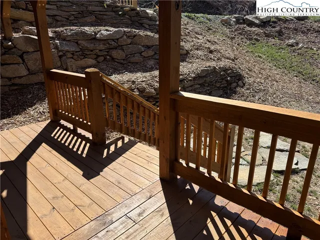 a view of a house with a yard and deck